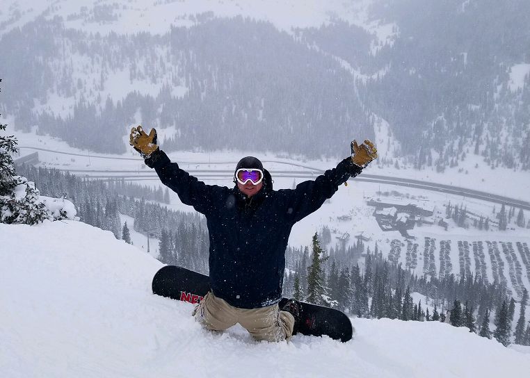 A snowboarder with MGUS riding down a steep mountain, hands in the air, symbolizing resilience and triumph